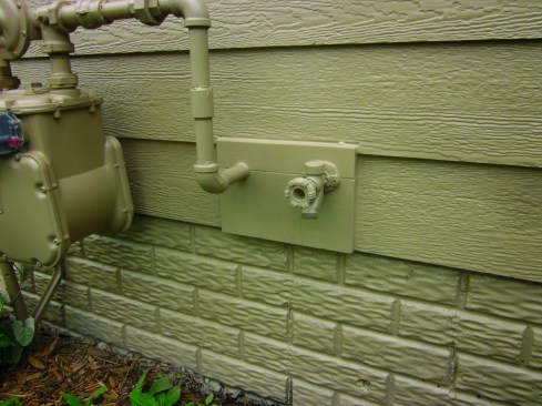 The correct way to deal with penetrations is to use a split mounting block. Beveled to drain downward, the split is also sealed with caulk.