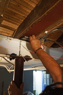 Steel shims are placed between the new beam and the old basement girders