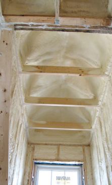 At roughly R-6 per inch, the 2x8 framing bays approach a nominal R-44. Two doghouse dormers were also insulated with closed-cell foam.