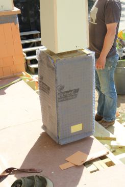 The crew wrapped the post bases with the same MortairVent rainscreen fabric that was used under wood shingles in the upper stories. The fabric creates an air space that promotes drying for the pre-primed shingles and extends the service life of the paint job.