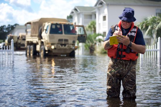 A member of the U.S. Coast Guard’s Gulf Strike Team jots down in his notebook what apartments have been evacuated after floodwaters from the Waccamaw River took over people's homes in Horry County, South Carolina, Sept. 19, 2018. U.S. Coast Guard photo by Petty Officer 1st Class Jon-Paul Rios.