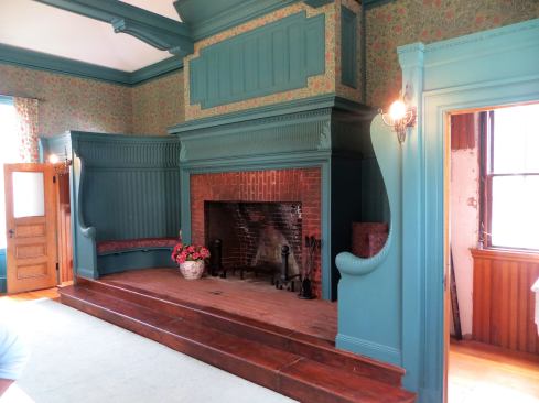 An octagonal shaped billiard room with its large Rumford fireplace and raised seating area is more in the style of an old English estate.