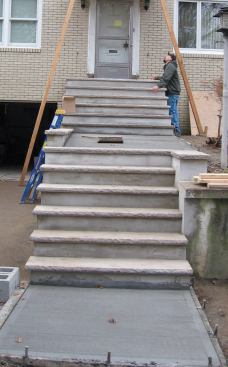 After floating the wet concrete with a wood float, we waited until all the bleed water had evaporated before giving the walkways a broom finish for traction.