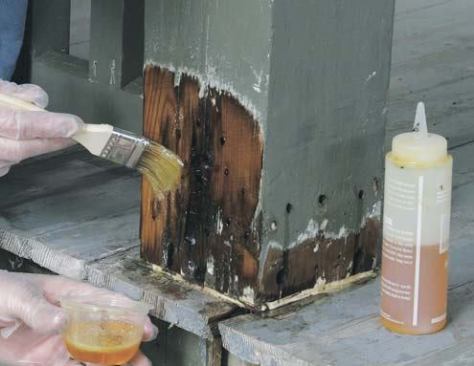 To fully saturate the damaged area, the author alternates between squirting consolidant into the holes and brushing it on the surface.