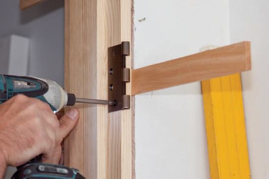 The author initially installs only the outlying screws so that he can adjust the tapered shims in or out when finetuning the jamb.