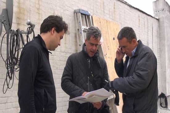 Passive House consultant Cramer Silkworth (left), architect James Wagman (center), and remodeler Jose Maldonado (right) meet on the roof of a brownstone on Prospect Place in Brooklyn, New York, to discuss details of the exterior insulated finish system (EIFS) cladding for a new addition under construction at the rear of the building in April, 2014.