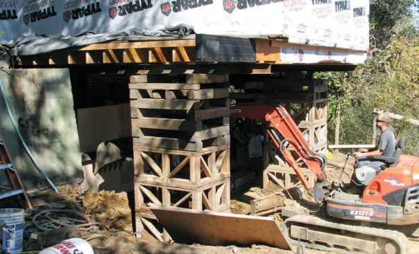 This allowed the cribbing and shoring contractor to support the entire house frame with several long steel I-beams, so that excavation under the house could proceed — a combination of mini-excavator work and hand-digging.