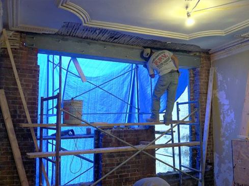 With the outer steel channel in place, the remaining two brick wythes were gradually removed from the inside, allowing us to install the 2-by stock and a second steel channel for the flitch-beam assembly. The assembly was bolted together, completing the flitch beam.