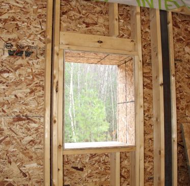 An interior view of one of the small north-facing window openings at the rough framing stage.