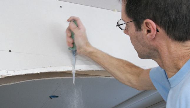 As I cut the drywall to the shape of the arch, I bevel the edge to accommodate the profile of the bullnose bead.