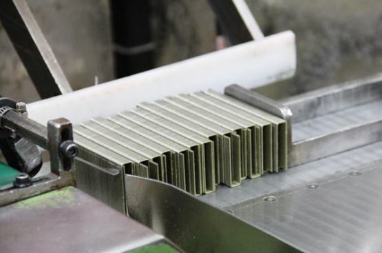 These strips of staples were punched from the edge-glued wire you saw in the previous two slides. 
Click here for a video that shows them coming out of the punch press and being stacked and boxed by a machine.