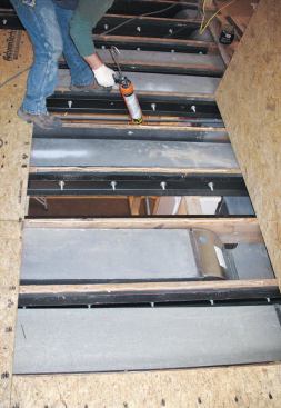 Steel reinforcement bolted to the existing floor joists.