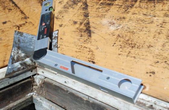 I use a Bosch digital miter gauge to find the angle of intersection, or dihedral, of the two roof planes.