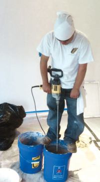 At the end of the day, we used a paddle and two 5-gallon buckets to mix the base coat for the walls and the ceiling.