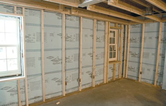 The finished basement walls were insulated to R-25 with a combination of 2-inch XPS foam and R-15 fiberglass batts.