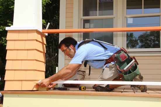 Shimming the bottom rail to the correct height. Balusters are already pre-cut to length.