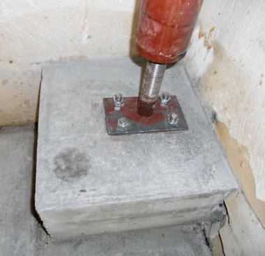 Steel columns support the beam at the ends and in the center.