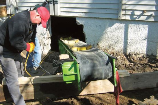 Boyer's crew broke up the rest of the slab floor with their jackhammer, then hand-loaded the debris onto a rented 26-foot-long portable dirt conveyor.