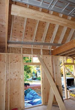 In an advanced frame, headers are minimized in favor of insulation cavities. All framing is vertically aligned and point loads are distributed directly through to the foundation. In this sloped ceiling section, squash blocks carry the rafters’ load path over the second-floor rim joist.