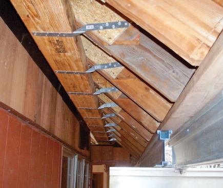 The beam is attached with twist straps to AdvanTech gussets nailed to the sides of the rafters.