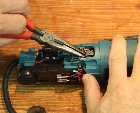 Release brush by moving clip off to the side.