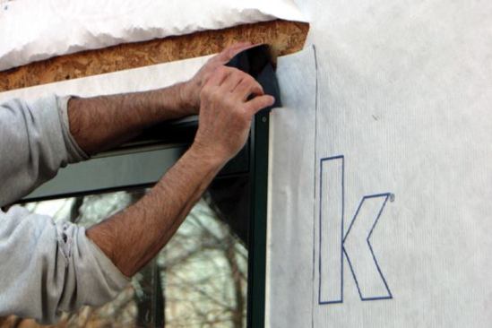 ... lapping it over the top of the jamb flashings. 
Note: Applying the head flashing directly to the sheathing provides another level of protection. If any moisture were to find its way behind the housewrap and seep down to the window, it would encounter the head flashing and be directed over the windowhead flange, not behind it.