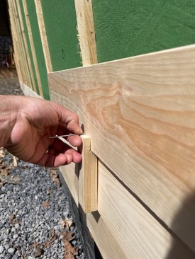 The author uses a simple, site-made jig to align nails precisely so they penetrate only one board.