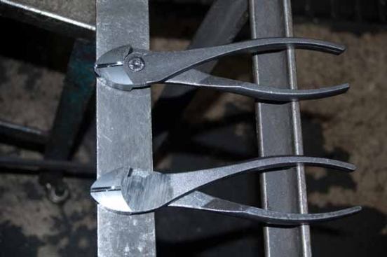 After milling the joint surfaces and shaping the cutting edges, the two halves of a tool are riveted together and the rivet is ground flush as shown on these diagonal cutters.