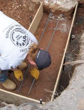 The concrete is reinforced with rebar held off the ground with chairs.