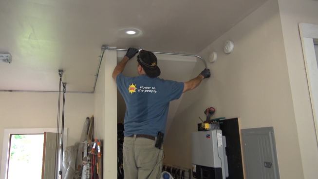 While the panels are being mounted on the roof, electrician Ted Houghton completes the indoor portion of the conduit run from the roof, using metallic conduit. When all the conduit is connected, the conductors and ground wire serving the roof array will get pulled through and connected to the DC disconnect switch at the inverter.