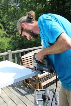 Jeff trims the base of the fridge end panel with the jigsaw ...