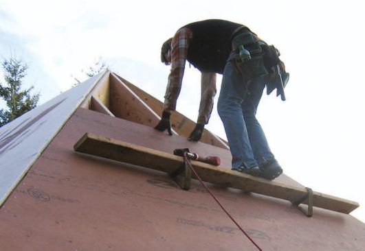 The author's crew sets up toeboards for roof pitches steeper than 8/12.