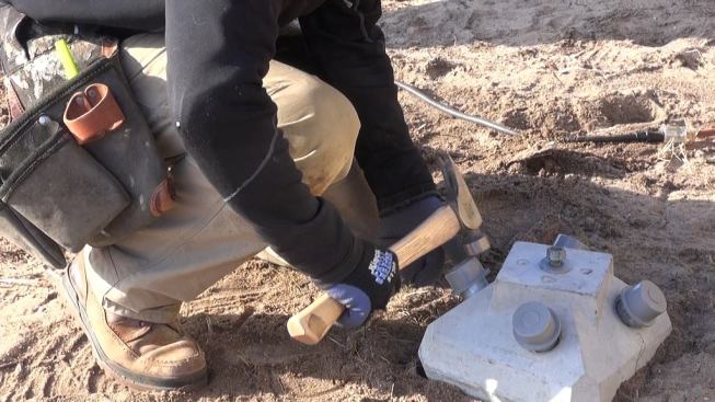 Tapping the rubber cap down lightly with a hammer.