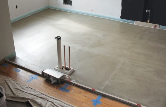 The surface was skim-coated and edged with dams and a perimeter expansion joint in preparation for electric heat mats and self-leveling underlayment.
