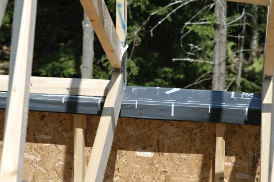 The carpenters attached an OSB gusset to the top plate of the 2x4 bearing walls.
