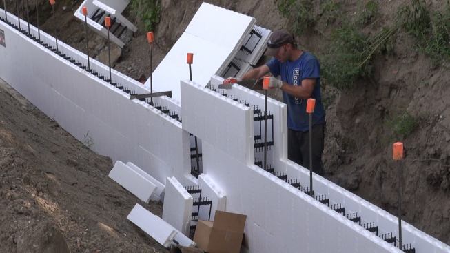 At the center of the wall, sections have to be trimmed with a handsaw to fit into the remaining gap.