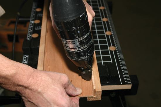 By using a plywood spacer while nailing the first panel to the second baluster, the author leaves room for the next perpendicular panel to slip snugly into place.