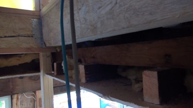 A look at the interface between the old first-floor ceiling of the house (originally the home’s only ceiling) and the newly built second floor structure. The old ceiling’s frame and finish were left mostly intact during the remodel, allowing the homeowners, a young family, to stay in place during construction. Supported by an independent post and beam skeleton, the new second floor is structurally independent of the old ceiling, which remains held up by the home’s original walls as it always has been.