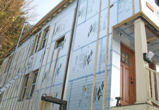 One-by-three strapping screwed to the framing on 16-inch centers holds the double foam layer securely in place and provides a drying and drainage channel behind the siding. Seams on both layers were taped to block air movement.