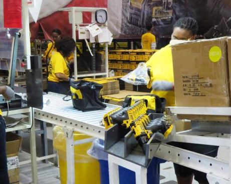 These 20V MAX impact and drill drivers are being packaged together in combo kits. The production cells for these tools are set up end-to-end. Tools advance left-to-right on one and right-to-left on the other so they end up at the same place when they’re finished.