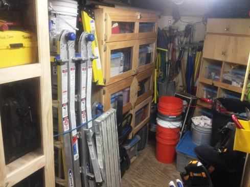 The space between the console and attached cabinets is occupied by several ladders—held in place by bungees so they won’t fall out in transit