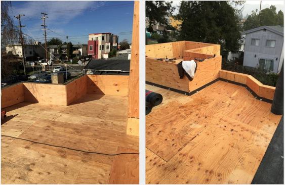 The framed and sheathed roof and parapet, with a fillet applied to the roof/parapet joint (right) in preparation for roll roofing.