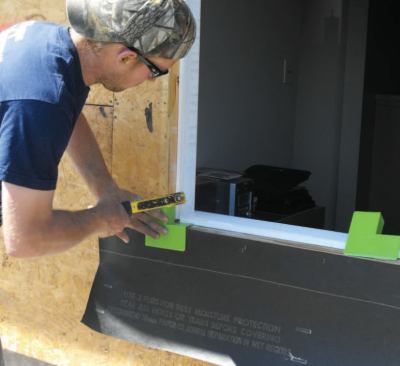 I use prefabricated plastic corners made by Grace (the company calls them "Vycorners"). These get tacked into both corners.