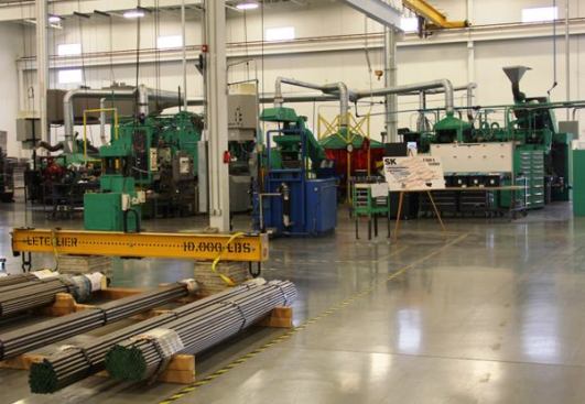 The machines in this photo turn steel into sockets, not by machining or drilling, but by pressing the metal with a series of dies that form it to the shape of a socket. It takes a tremendous amount of force to do this.