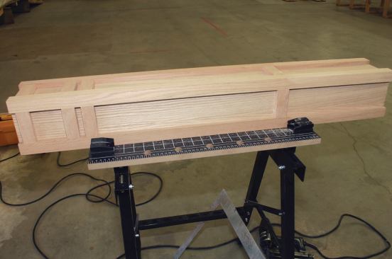 The newel is finished with a 12-inch-wide oak base, then capped and trimmed on site.