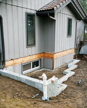 Both the stepped stem wall for the new addition and the old bumpout are visible.