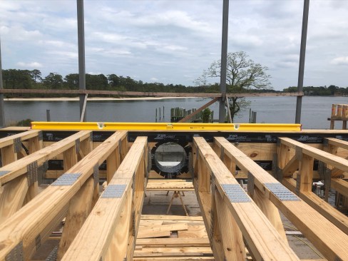 Running HVAC ducts in the open webs of floor trusses offers a distinct advantage. On this job, the truss layout was coordinated with prefabbed openings in the steel girders.
