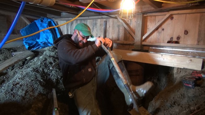 Shane digs into the spoil and overdig from the foundation pier hole for gravel to backfill the new Sonotube. After a few cold days, the first few inches of material has frozen solid.