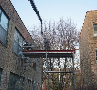 The beam is positioned so it can be lifted in through a window into the apartment.