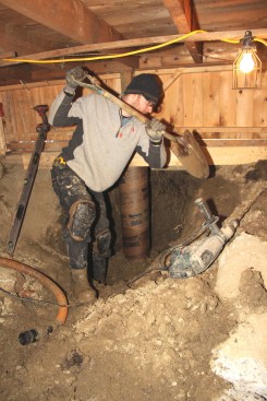 The crew shoveled loose gravel around the base of the Sonotubes to hold them steady as they filled the tubes with concrete.